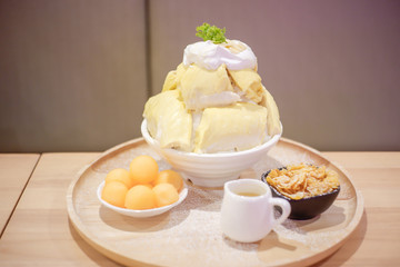 Bingsu Durian with Durian ice cream and Whipped cream served with condensed milk and melon.