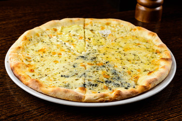 Appetizing hot Four Cheese Pizza on table