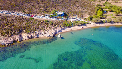 Aerial bird's eye view photo taken by drone of famous rocky beach of Livadi Geranou with turquoise clear waters, Patmos island, Greece