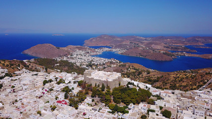 Obraz premium Aerial bird's eye view photo taken by drone of massive fortified stone Monastery of Saint John the Apostle with views to Aegean sea, Patmos island, Greece