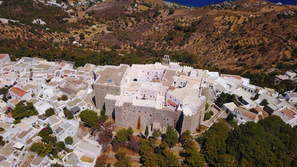 Aerial bird's eye view photo taken by drone of massive fortified stone Monastery of Saint John the Apostle with views to Aegean sea, Patmos island, Greece