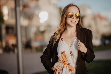 Beautiful young sexy woman in sunglasses in the city