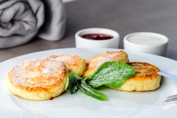 Sweet delicious cottage cheese pancakes, syrniki, curd fritters 