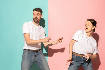 A couple of young man and woman dancing hip-hop at studio.