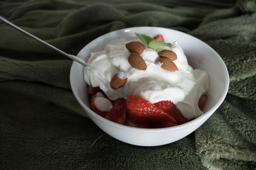 strawberries with whipped cream in a bowl
