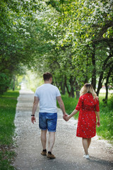 Obraz premium Beautiful young couple man and pregnant woman. Happy family concept.