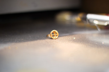 Gold ring with dust on the industrial table