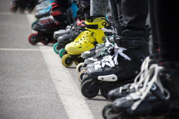 Plakat Close up view of wheels befor skating.Legs in rollskikovye skates are lined up in a row