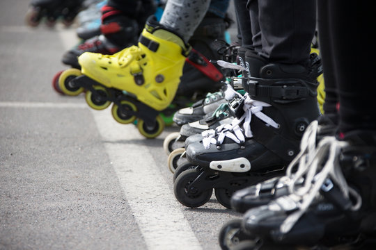 Close up view of wheels befor skating.Legs in rollskikovye skates are lined up in a row
