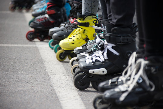 Close up view of wheels befor skating.Legs in rollskikovye skates are lined up in a row