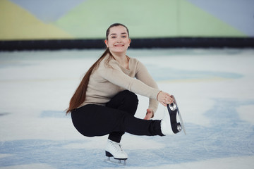 Cute girl figure skating at sports arena