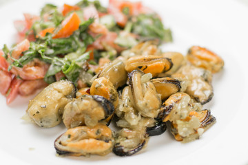 Fried mussels with fresh vegetable salad.