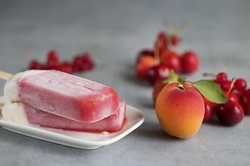 Fruit sorbet of summer fruits and berries on white plate.