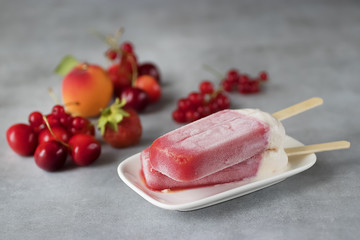Fruit sorbet of summer fruits and berries on gray background.
