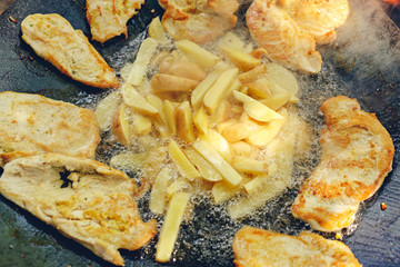 family time - chicken meat and potato being grilled in a barbecue.