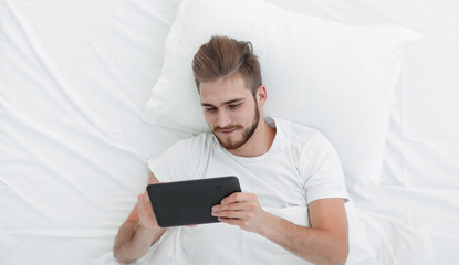 top view.young man typing on a digital tablet