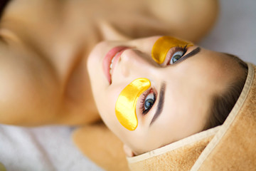 Beauty and Care. Girl with Beautiful Skin in Beauty Salon. Pure Fresh Skin. Woman with Eye Patches. High Resolution