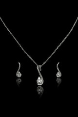 Closeup of Diamond Necklace with Tops having many Diamonds. Isolated on black background.