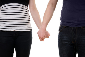 mid section of unrecognizable couple holding hands