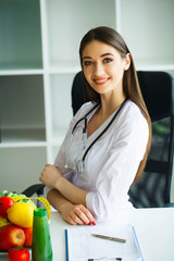 Health and Beauty. Portrait of a Happy Dietitian in the Light Room. Healthy Nutrition. A Doctor...