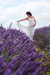 Portrait of pregnant woman in fairy field of lavender.
