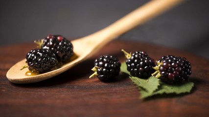 Blackberrys on wooden table.Blackberries on wooden spoon. Berrie fruit. Blackberry background