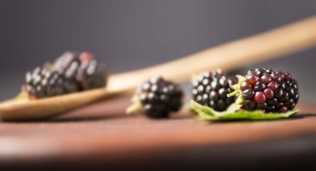 Blackberrys on wooden table.Blackberries on wooden spoon. Berrie fruit. Blackberry background