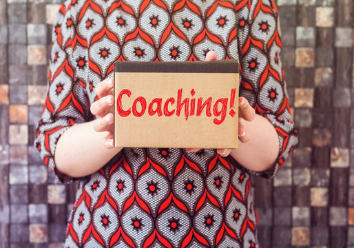 businesswoman holding cardboard with coatching
