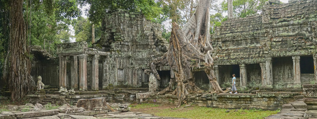 Young female traveler exploring the ancient remnants of old Buddhist temples.