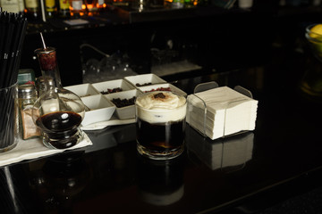 White Russian Cocktail with coffee beans and cinnamon garnished .