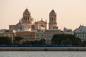 View of the city of Cadiz (Andalucia, Spain), especially its Cathedral, with a fantastic sunset light from the ferry that connects it with El Puerto de Santa Maria. Summer of 2016.