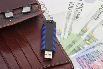 Electronic storage devices are visible in the wallet, next to the banknotes of the EURO The concept of using modern digital technologies in financial transactions