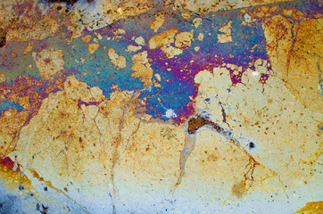 gasoline stain on a water surface. colorful textured abstract background. ecological water problems 