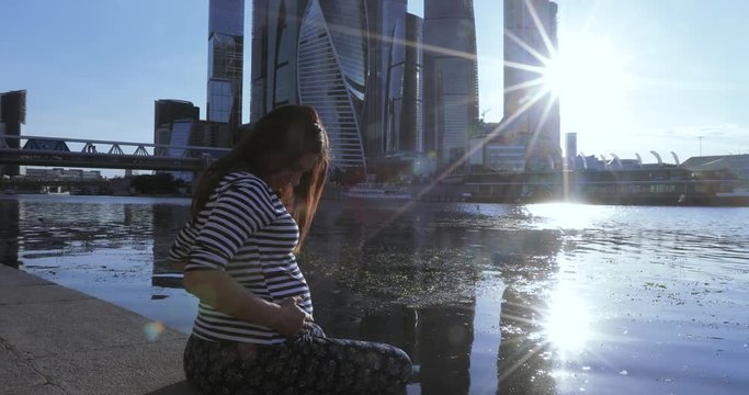 Pregnant on the river bank city