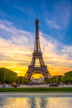 Paris Eiffel Tower and Champ de Mars in Paris, France. Eiffel Tower is one of the most iconic landmarks in Paris. The Champ de Mars is a large public park in Paris.