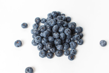 Handful of large blueberries on white background