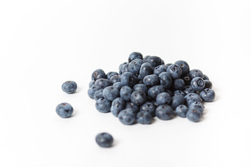 Handful of large blueberries on white background