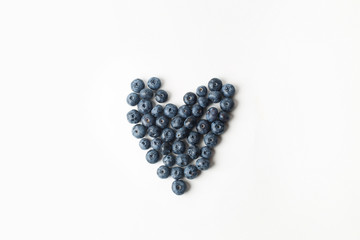 Heart of blueberries on white background