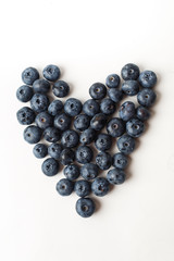 Heart of blueberries on white background