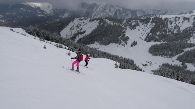 Skiers Skiing On The Difficulty Mountain Downhill In Winter Holidays