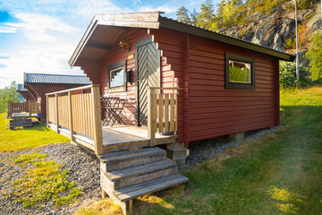 Red camping cabins for travelers at sunset lights, Sweden