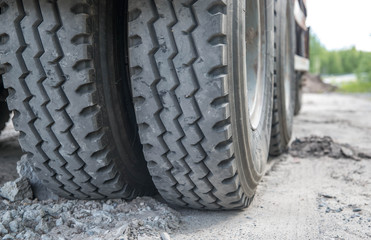 Truck in the sand, wheel close-up, construction. Traces from the truck on the sand.