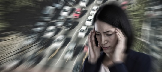 Composite image of businesswoman suffering from headache
