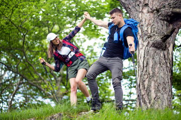 Couple of hikers have fun on their hiking trip