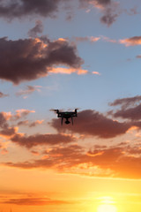 Fototapeta na wymiar flying drone on the background of a beautiful sunset / beautiful sky drone doing its job