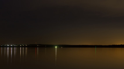 Fototapeta na wymiar river at night full calm water surface / minimal composite night landscape