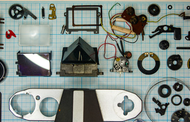 parts old retro film SLR camera on graph paper