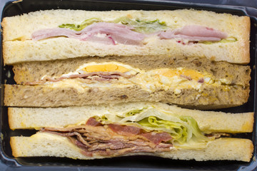 Buffet sliced sandwiches cut with different filling
