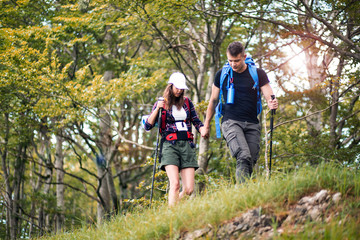 Naklejka na ściany i meble Couple of hikers have fun on their hiking trip