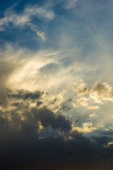 Landscape with dramatic light - beautiful golden sunset with saturated sky and clouds.